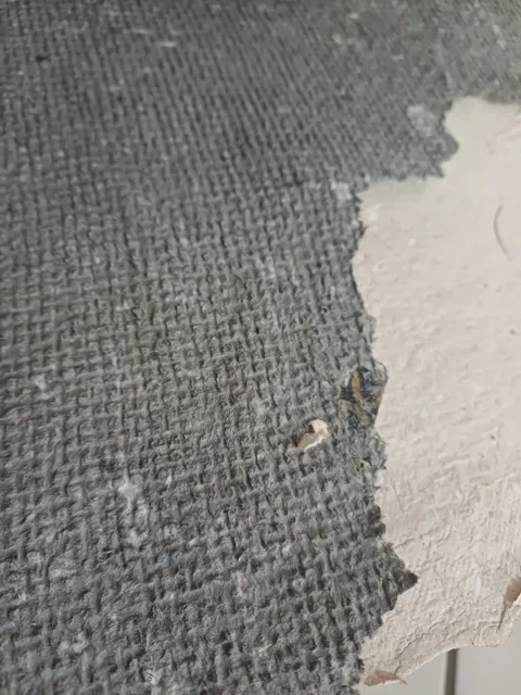 Close-up of a dark charcoal-grey sheet with a coarse woven texture